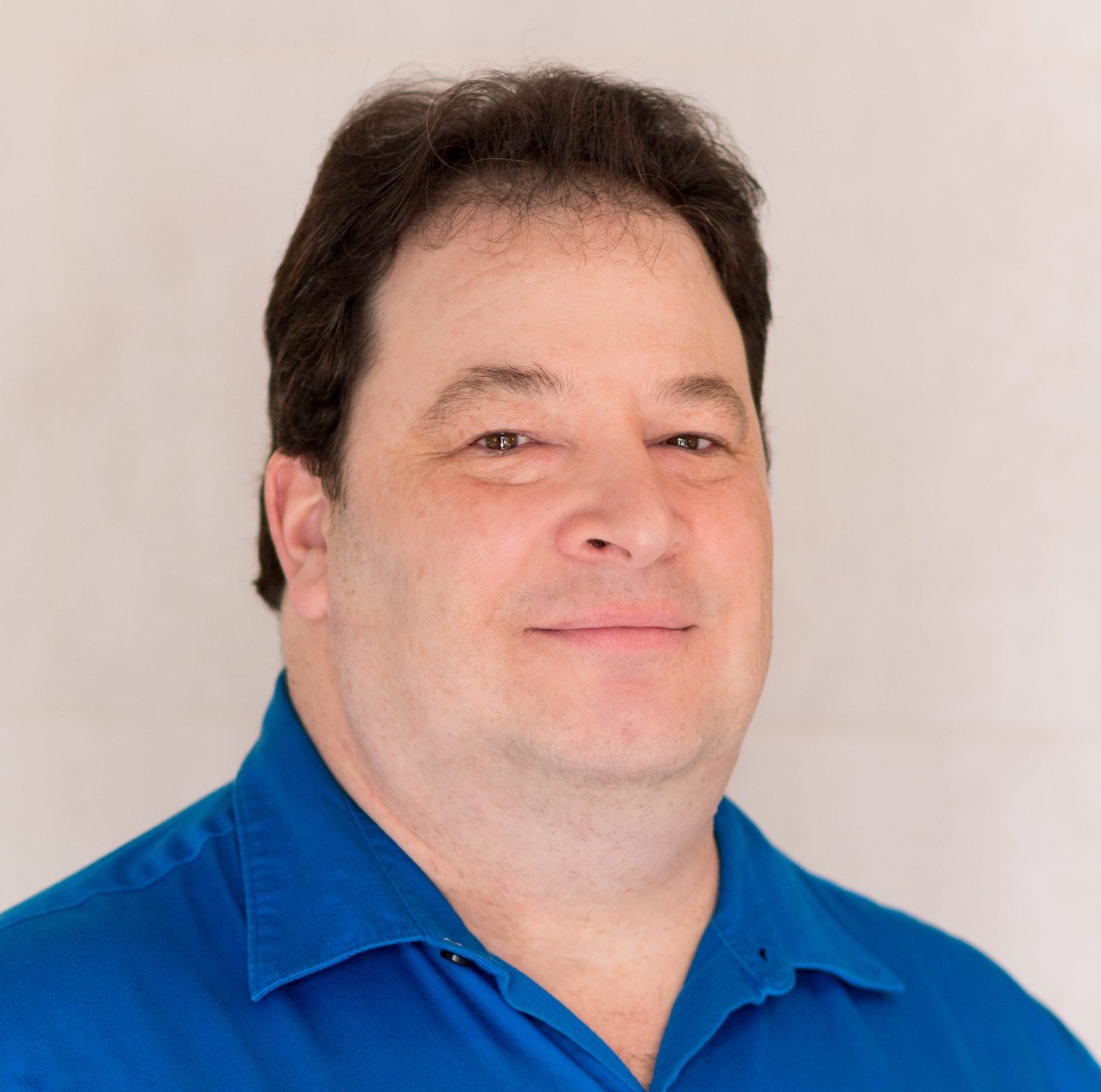 David Bromberg Psychologist Headshot Blue Shirt Dark Hair